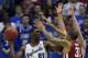 LAWRENCE, KS - FEBRUARY 24: Joel Embiid #21 of the Kansas Jayhawks looks to pass the ball against D.J. Bennett #31 of the Oklahoma Sooners in the second half at Allen Fieldhouse on February 24, 2014 in Lawrence, Kansas. Kansas won 83-75. (Photo by Ed Zu