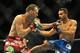 Jul 5, 2014; Las Vegas, NV, USA; George Roop (rd gloves) fights Rob Font (blue gloves) during a bantamweight fight at Mandalay Bay Events Center. Mandatory Credit: Stephen R. Sylvanie-USA TODAY Sports