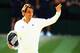 LONDON, ENGLAND - JULY 06: Roger Federer of Switzerland waves to the fans as he holds the runner up trophy after the Gentlemen's Singles Final match against Novak Djokovic of Serbia on day thirteen of the Wimbledon Lawn Tennis Championships at the All En