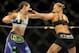 Jul 5, 2014; Las Vegas, NV, USA; Ronda Rousey (red gloves) trades punches with Alexis Davis (blue gloves) during a women's bantamweight title bout at Mandalay Bay Events Center. Mandatory Credit: Stephen R. Sylvanie-USA TODAY Sports