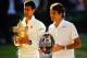 LONDON, ENGLAND - JULY 06: Novak Djokovic of Serbia poses with the Gentlemen's Singles Trophy next to Roger Federer of Switzerland following his victory in the Gentlemen's Singles Final match on day thirteen of the Wimbledon Lawn Tennis Championships at