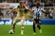 NEWCASTLE UPON TYNE, ENGLAND - SEPTEMBER 25: Ross McCormack of Leeds United holds off Vurnon Anita of Newcastle United during the Capital One Cup Third Round match between Newcastle United and Leeds United at St James' Park on September 25, 2013 in Newca