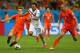 SALVADOR, BRAZIL - JULY 05: Stefan De Vrij (L) of the Netherlands tackles Marcos Urena of Costa Rica as Ron Vlaar closes in during the 2014 FIFA World Cup Brazil Quarter Final match between the Netherlands and Costa Rica at Arena Fonte Nova on July 5, 2