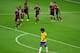 BELO HORIZONTE, BRAZIL - JULY 08: A dejected Dante of Brazil reacts as Andre Schuerrle of Germany celebrates scoring his team's seventh goal with teammates during the 2014 FIFA World Cup Brazil Semi Final match between Brazil and Germany at Estadio Minei