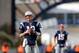 Tom Brady (12, left) is still in the picture, while Ryan Mallett (15, right) has faded further into the background.