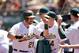 OAKLAND, CA - JULY 06: Stephen Vogt #21 of the Oakland Athletics is congratulated by teammates after he scored on a hit by Nate Freiman #35 in the fourth inning of their game against the Toronto Blue Jays at O.co Coliseum on July 6, 2014 in Oakland, Cali