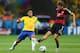 BELO HORIZONTE, BRAZIL - JULY 08: Hulk of Brazil and Thomas Mueller of Germany compete for the ball during the 2014 FIFA World Cup Brazil Semi Final match between Brazil and Germany at Estadio Mineirao on July 8, 2014 in Belo Horizonte, Brazil. (Photo b