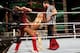 Summer Rae pins Layla in the corner with her long legs.