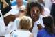 LONDON, ENGLAND - JULY 01: Serena Williams of the United States recieves treatment during the warm up before their Ladies Doubles second round match with Venus Williams (l) against Kristina Barrois of Germany and Stefanie Voegele of Switzerland on day ei