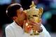 LONDON, ENGLAND - JULY 06: Novak Djokovic of Serbia kisses the Gentlemen's Singles Trophy following his victory in the Gentlemen's Singles Final match against Roger Federer of Switzerland on day thirteen of the Wimbledon Lawn Tennis Championships at the