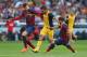 BARCELONA, SPAIN - MAY 17: Adrian Lopez of Club Atletico de Madrid is tackled by Gerard Pique and Javier Mascherano of FC Barcelona during the La Liga match between FC Barcelona and Club Atletico de Madrid at Camp Nou on May 17, 2014 in Barcelona, Spain.