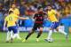 BELO HORIZONTE, BRAZIL - JULY 08: Sami Khedira (C) of Germany runs past Oscar of Brazil with the ball during the 2014 FIFA World Cup Brazil Semi Final match between Brazil and Germany at Estadio Mineirao on July 8, 2014 in Belo Horizonte, Brazil. (Photo