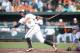 BALTIMORE, MD - JUNE 30: Adam Jones #10 of the Baltimore Orioles hits a solo home run in the first inning during a baseball game against the Baltimore Orioles on June 30, 2014 at Oriole Park at Camden Yards in Baltimore, Maryland. (Photo by Mitchell Lay