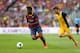 BARCELONA, SPAIN - MAY 17: Alex Song of FC Barcelona beats David Villa of Club Atletico de Madrid during the La Liga match between FC Barcelona and Club Atletico de Madrid at Camp Nou on May 17, 2014 in Barcelona, Spain. (Photo by Alex Livesey/Getty Imag
