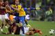 ROME, ITALY - APRIL 02: Jonathan Biabiany (C) and Cristian Molinaro of FC Parma competes for the ball with Mehdi Benatia of AS Roma during the Serie A match between AS Roma and FC Parma at Olimpico Stadium on April 2, 2014 in Rome, Italy. (Photo by Paol