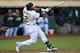OAKLAND, CA - JULY 08: Yoenis Cespedes #52 of the Oakland Athletics hits an RBI single scoring Coco Crisp #4 in the bottom of the third inning against the San Francisco Giants at O.co Coliseum on July 8, 2014 in Oakland, California. (Photo by Thearon W.