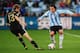 CAPE TOWN, SOUTH AFRICA - JULY 03: Thomas Mueller of Germany challenges Carlos Tevez of Argentina during the 2010 FIFA World Cup South Africa Quarter Final match between Argentina and Germany at Green Point Stadium on July 3, 2010 in Cape Town, South Afri