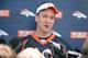 Jun 10, 2014; Denver, CO, USA; Denver Broncos quarterback Peyton Manning (18) speaks to the media following mini camp drills at the Broncos practice facility. Mandatory Credit: Ron Chenoy-USA TODAY Sports