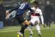 MILAN, ITALY - JANUARY 19: Luc Castaignos of FC Internazionale Milano competes for the ball with Kevin Constant of Genoa CFC during the TIM Cup match between FC Internazionale Milano and Genoa CFC at Stadio Giuseppe Meazza on January 19, 2012 in Milan, I