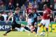 HIGH WYCOMBE, ENGLAND - APRIL 18: Emile Sinclair of Northampton Town looks to control the ball watched by Sam Wood and Matt Bloomfield of Wycombe Wanderers during the Sky Bet League Two match between Wycombe Wanderers and Northampton Town at Adams Park o