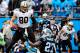 CHARLOTTE, NC - DECEMBER 22: Jimmy Graham #80 of the New Orleans Saints has words for Quintin Mikell #27 of the Carolina Panthers after beating him for a touchdown during their game at Bank of America Stadium on December 22, 2013 in Charlotte, North Caro