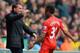 NORWICH, ENGLAND - APRIL 20: Raheem Sterling of Liverpool celebrates scoring the opening goal with Manager Brendan Rodgers of Liverpool during the Barclays Premier League match between Norwich City and Liverpool at Carrow Road on April 20, 2014 in Norwic