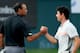 DUBAI, UNITED ARAB EMIRATES - JANUARY 31: Rory McIlroy of Northern Ireland and Tiger Woods of the USA shake hands on the 18th greenduring the second round of the 2014 Omega Dubai Desert Classic on the Majlis Course at the Emirates Golf Club on January 31