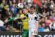 SWANSEA, WALES - MARCH 29: Ben Davies of Swansea City tackled by Gary Hooper of Norwich City during the Barclays Premier League match between Swansea City and Norwich City at Liberty Stadium on March 29, 2014 in Swansea, Wales. (Photo by Tony Marshall/G