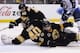 BOSTON, MA - JANUARY 4: Matt Bartkowski #43, Tuukka Rask #40 and Johnny Boychuk #55 of the Boston Bruins try to stop the puck against the Winnipeg Jets at the TD Garden on January 4, 2014 in Boston, Massachusetts. (Photo by Brian Babineau/NHLI via Getty