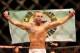 Jul 16, 2014; Atlantic City, NJ, USA; Lucas Martins holds up a flag after winning a featherweight bout at Revel Casino. Mandatory Credit: Bill Streicher-USA TODAY Sports