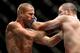 Jul 16, 2014; Atlantic City, NJ, USA; Donald Cerrone (red gloves) locks up with Jim Miller (blue gloves) during a 5-round lightweight bout at Revel Casino. Mandatory Credit: Bill Streicher-USA TODAY Sports