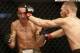 Aug 17, 2013; Boston, MA, USA; Conor McGregor (black shorts) and Max Holloway (white shorts) fight during a UFC featherweight match at the TD Garden. McGregor won after three rounds by judges decision. Mandatory Credit: Winslow Townson-USA TODAY Sports