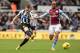 NEWCASTLE UPON TYNE, ENGLAND - FEBRUARY 23: Mathieu Debuchy of Newcastle United takes a shot at goal past Fabian Delph of Aston Villa during the Barclays Premier League match between Newcastle United and Aston Villa at St James' Park on February 23, 2014