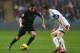 SWANSEA, WALES - JANUARY 01: Jesus Navas (L) of Manchester City runs at Ben Davies (R) of Swansea City during the Barclays Premier League match between Swansea City and Manchester City at the Liberty Stadium on January 1, 2014 in Swansea, Wales. (Photo b