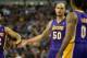 Apr 2, 2014; Sacramento, CA, USA; Los Angeles Lakers center Robert Sacre (50) high fives guard Kendall Marshall (12) and forward Nick Young (0) after a basket and foul against the Sacramento Kings during the second quarter at Sleep Train Arena. Mandatory
