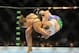 Jul 5, 2014; Las Vegas, NV, USA; Ronda Rousey (red gloves) takes down Alexis Davis (blue gloves) during the first round of a bantamweight fight at Mandalay Bay Events Center. Mandatory Credit: Stephen R. Sylvanie-USA TODAY Sports