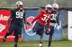 FOXBORO, MA - JULY 26: Marcus Forston #98, Devin McCourty #32 and Leon Washington #30 stretch during the first day of New England Patriots Training Camp at Gillette Stadium on July 26, 2013 in Foxboro, Massachusetts. (Photo by Jim Rogash/Getty Images)