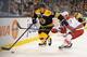 Murphy is dwarfed and outmuscled along the boards by Boston's Gregory Campbell.