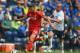 PRESTON, LANCASHIRE - JULY 19: Keith Keane of Preston in action with Fabio Borini of Liverpool during the pre season friendly match between Preston North End and Liverpool at Deepdale on July 19, 2014 in Preston, Lancashire. (Photo by Michael Regan/Gett