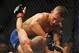 May 24, 2014; Las Vegas, NV, USA; TJ Dillashaw (blue) pins down Renan Barao (red) during their UFC 173 bantamweight championship bout at MGM Grand Garden Arena. Dillashaw won the bout by way of TKO. Mandatory Credit: Stephen R. Sylvanie-USA TODAY Sports