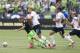 Harry Kane battles with Seattle's Osvaldo Alonso for the ball this past Saturday.