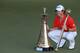 DUBAI, UNITED ARAB EMIRATES - NOVEMBER 25: Rory McIlroy of Northern Ireland with the DP World Tour Championship Trophy and the Race to Dubai Trophy (l) after his win during the final round of the 2012 DP World Tour Championship on the Earth Course at Jum