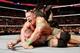John Cena and Roman Reigns both apply a submission hold to Randy Orton.