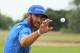 HOYLAKE, ENGLAND - JULY 20: Dustin Johnson of the United States reaches for a golf ball on the practice ground during the final round of The 143rd Open Championship at Royal Liverpool on July 20, 2014 in Hoylake, England. (Photo by Mike Ehrmann/Getty Im