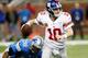 DETROIT, MI - DECEMBER 22: Eli Manning #10 of the New York Giants escapes the rush of Nick Fairley #98 of the Detroit Lions during the fourth quarter at Ford Field on December 22, 2013 in Detroit, Michigan. New York won the game in overtime 23-20. (Photo