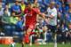 PRESTON, LANCASHIRE - JULY 19: Keith Keane of Preston in action with Fabio Borini of Liverpool during the pre season friendly match between Preston North End and Liverpool at Deepdale on July 19, 2014 in Preston, Lancashire. (Photo by Michael Regan/Gett