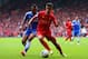 LIVERPOOL, ENGLAND - APRIL 27: Ashley Cole of Chelsea and Philippe Coutinho of Liverpool compete for the ball during the Barclays Premier League match between Liverpool and Chelsea at Anfield on April 27, 2014 in Liverpool, England. (Photo by Clive Bruns
