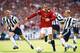 LONDON, UNITED KINGDOM - AUGUST 11: Manchester United player Eric Cantona (c) beats Steve Watson and David Batty (r) during the FA Charity Shield match between Manchester United and Newcastle United at Wembley Stadium on August 11, 1996 in London, England