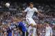 MADRID, SPAIN - OCTOBER 02: Raphael Varane (R) of Real Madrid CF heads the ball beside Ragnar Sigurdsson of FC Copenhagen during the UEFA Champions League match between Real Madrid CF and FC Copenhagen at Estadio Santiago Bernabeu on October 2, 2013 in M