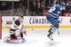 TORONTO, CANADA - DECEMBER 6: Tyler Bozak #42 of the Toronto Maple Leafs jumps through the crease as goalie Martin Brodeur #30 of the New Jersey Devils makes a glove save during NHL game action December 6, 2011 at Air Canada Centre in Toronto, Ontario, C